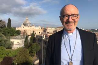 Cardinal Michael Czerny, undersecretary for the Vatican&#039;s Migrants and Refugees Section, stands on the terrace of the Jesuit residence in Rome where he lives and, during the coronavirus lockdown, works.