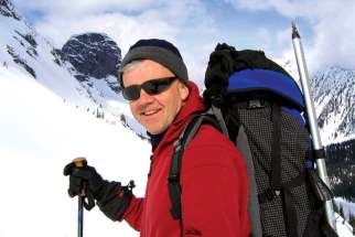Ecologist Fr. John McCarthy, seen above hiking in the B.C. mountains, connects science and faith.