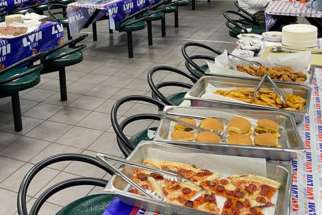 Food is laid out for the Super Bowl community dinner for homeless men in Toronto, Feb 12, 2023.