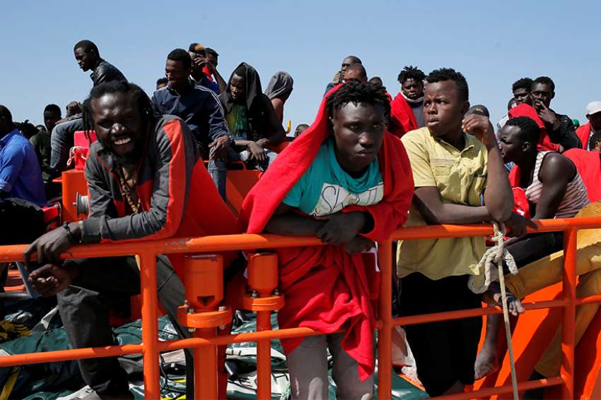 Migrants, intercepted aboard a makeshift boat in the Mediterranean Sea, are seen after arriving on a rescue boat July 22 at the Spanish port of Algeciras. 