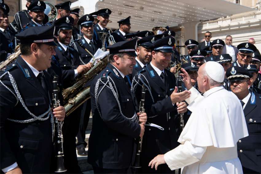 Pope Francis greets band members during an audience with members of the Italian Prison Police in St. Peter&#039;s Square at the Vatican Sept. 14, 2019. The pope told prison guards, chaplains and officials that life sentences in prison without the possibility of parole are not the solution but a problem to be solved.