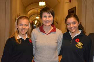 Italian astronaut Samantha Cristoforetti poses with two students during her visit to Loretto Abbey Catholic Secondary School. 