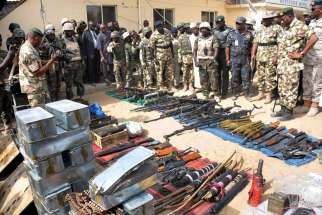 Nigerian President Goodluck Jonathan and military inspect weapons seized by Islamic militants in Baga, Nigeria, in this Feb. 26, 2015, file photo. 