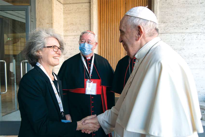 Pope Francis greets Sr. Nathalie Becquart, undersecretary of the Synod of Bishops, at the Vatican. The synod is raising hope for some, fear in others, on what it will mean for women.