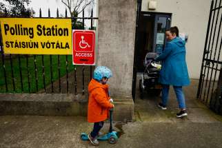 A woman arrives with children at a polling station in Dublin March 8, 2024, to vote on a referendum to redefine family and delete wording on stay-at-home mothers in the Irish Constitution.