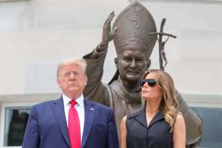 U.S. President Donald Trump and first lady Melania Trump pose outside the St. John Paul II National Shrine in Washington June 2, 2020, the 41st anniversary of the beginning of the pontiff&#039;s 1979 historic visit to Poland.