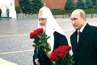 Russian Orthodox Patriarch Kirill of Moscow and Russian President Vladimir Putin walk to place flowers at a monument on National Unity Day in Red Square in Moscow in this Nov. 4, 2015, file photo. A group of Orthodox theologians has issued a statement condemning Patriarch Kirill’s support of the war in Ukraine.