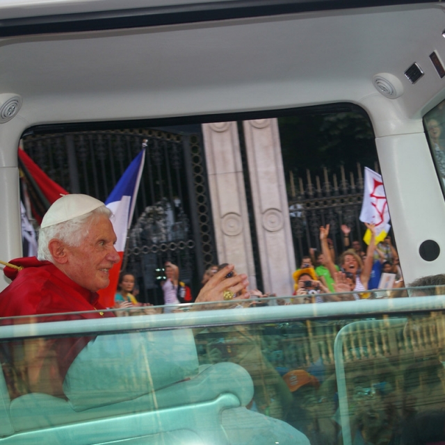Pope Benedict greets WYD pilgrims from the Popemobile.