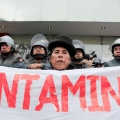 An Andean woman shouts slogans in front of police in Lima, Peru, during a mid-June protest against Peru&#039;s government support of extractive mining.