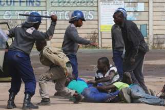 Riot police detain residents after a July 4 protest by taxi drivers turned violent in Harare, Zimbabwe. Violent protests in Zimbabwe reflect people&#039;s frustrations in extremely difficult times, a church official said.