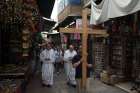 Catholic pilgrims walk past shops selling souvenirs May 20 on Via Dolorosa in Jerusalem&#039;s Old City. Many Holy Land residents say they are looking forward to Pope Francis&#039; May 24-26 visit, despite inconveniences of crowds and traffic.