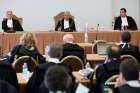 The judges of the Vatican City State criminal court -- Venerando Marano, Giuseppe Pignatone and Carlo Bonzano -- face dozens of lawyers in a makeshift Vatican courtroom July 27, 2021, as the trial of 10 defendants in a financial malfeasance case begins. Cardinal Angelo Becciu is among the defendants.