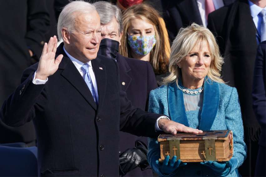  Joe Biden is sworn in as the 46th president of the United States as his wife, Jill Biden, holds a Bible on the West Front of the U.S. Capitol in Washington Jan. 20, 2021.