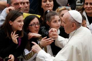 Pope Francis greets people as he visits St. Paul of the Cross Parish in Rome April 15. 