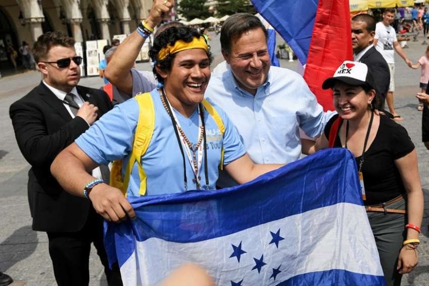 Panamanian President Juan Carlos Varela poses with pilgrims at the 2016 World Youth Day in Krakow, Poland. Cardinal Kevin J. Farrell says he hopes the January start date for the 2019 WYD in Panama won&#039;t keep students from attending.