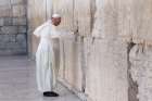 Pope Francis prays at the Western Wall in Jerusalem May 26. The pope stood for more than a minute and a half with his right hand against the wall, most of the time in silent prayer, before reciting the Our Father. Then he followed custom by leaving a wri tten message inside a crack between two blocks.