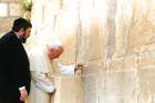Rabbi Michael Melchior watches as Pope John Paul II prays at Judiasm’s holiest site, the Western Wall, in Jerusalem in March 2000.
