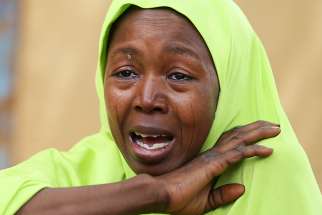A relative of one of the missing Nigerian school girls reacts Feb. 23 in Dapchi, Yobe State, after an attack on the village by suspected Boko Haram insurgents. A Nigerian bishop has appealed to the government to work for the rescue of the 110 girls of the Government Girls Science and Technical College.