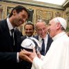 Pope Francis receives a soccer ball as gift from Italy&#039;s goalkeeper and captain, Gianluigi Buffon, during a private audience at the Vatican Aug. 13. Argentina will play Italy in a friendly soccer match Aug. 14 in the pope&#039;s honor.