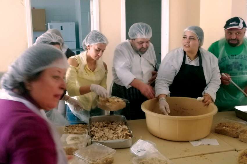Volunteers prepare containers of hot meals to be delivered to 230 needy people in Zahle, Lebanon. The initiative is a joint effort between the Jesuits of Lebanon and international businessman Nabil Chartouni, a Zahle native, especially known for his Lebanese company Faqra Catering.