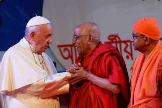 Pope Francis greets Buddhist representatives during an interreligious and ecumenical meeting for peace in the garden of the archbishop&#039;s residence in Dhaka, Bangladesh, Dec. 1, 2017.