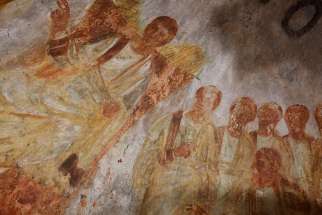 Jesus is seated on a throne with his disciples at his side in this fresco seen during the unveiling of two newly restored burial chambers in the Christian catacombs of St. Domitilla in Rome May 30. The Catacombs of St. Domitilla are believed to be the world&#039;s oldest Christian cemetery.