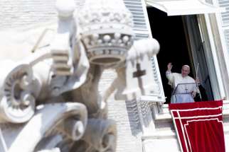 Pope Francis is pictured during his weekly Angelus prayer Aug. 24 from the window of his office in St. Peter&#039;s Square at the Vatican. The pope prayed for peace and marked Ukrainian Independence Day.