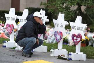 A young man reacts Oct. 29 at a makeshift memorial outside the Tree of Life synagogue in Pittsburgh. 