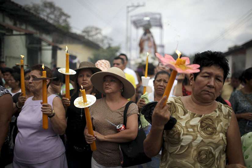 Worshippers carry candles April 2 as they participate in a Via Crucis (Way of the Cross) procession as part of Holy Week celebrations in the town of Izalco, El Salvador. 