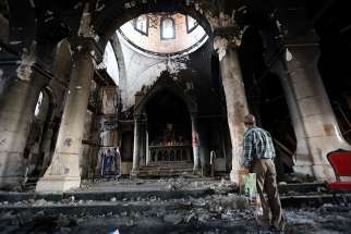 An Iraqi man inspects al-Tahira al-Kubra church near Mosul Nov. 15, 2016 after it was liberated from the Islamic State group. The Islamic State, Taliban and al-Shabaab have been added to U.S. Commission on International Religious Freedom’s list of “countries of particular concern.”