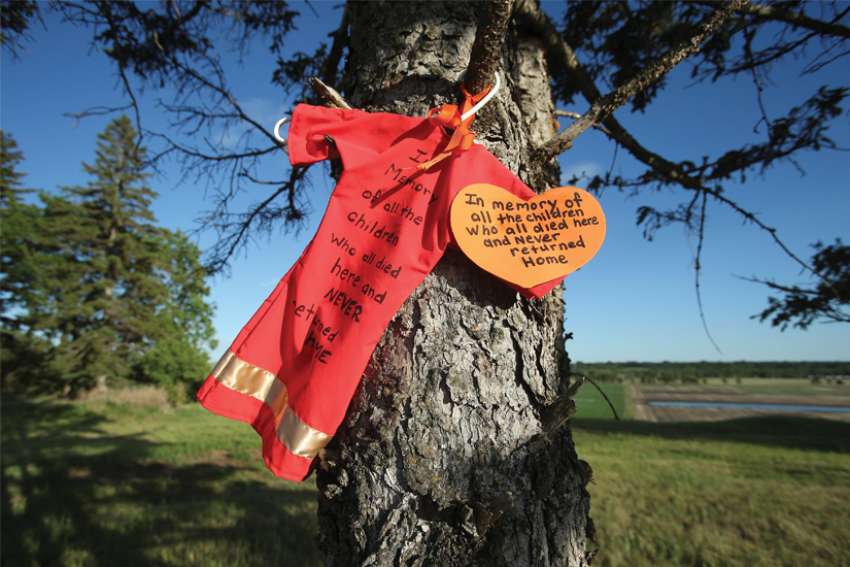 An offering is seen at the site of the former Brandon Indian Residential School in the wake of thousands of alleged unmarked graves found at former residential schools across Canada in 2001. Calgary Bishop Emeritus Fred Henry has challenged his brother bishops to demand proof of the thousands of residential school children alleged to have gone missing in the Indian residential school system.