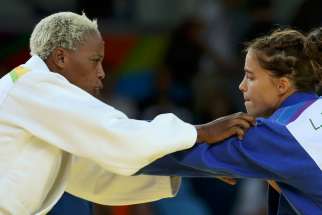 Refugee Olympic Team&#039;s Yolande Mabika, left, and Linda Bolder of Israel compete in judo during the Summer Olympics in Rio de Janeiro Aug. 10.