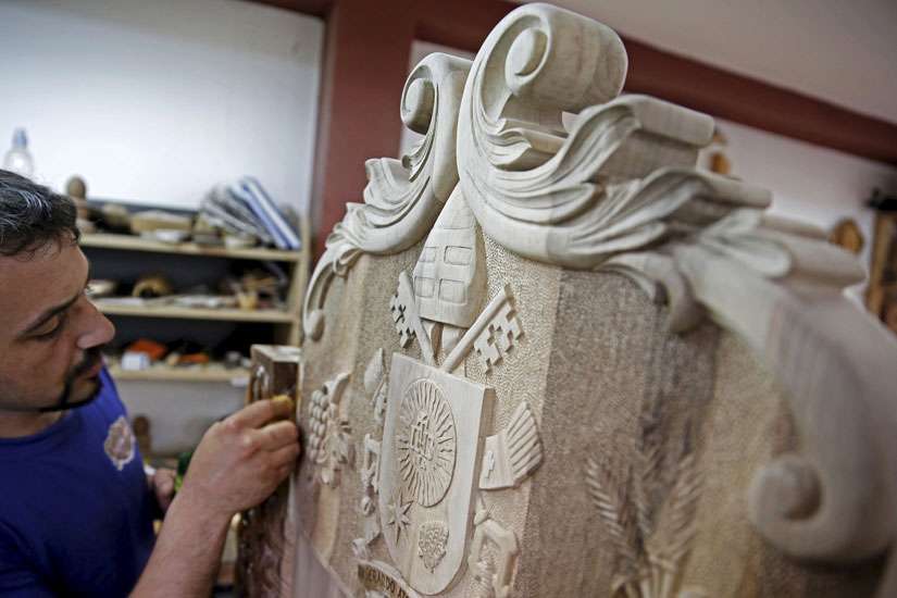 Bosnian woodcarver-sculptor Edin Hajderovac works on a chair for Pope Francis at his workshop in Zavidovici, Bosnia- Herzegovina, May 25. He and his father, Salem Hajderovac, are putting the finishing touches to the chair made from walnut trees, which Po pe Francis will use during his visit to Sarajevo. The father and son, both devoted Muslims, initiated the project in the belief that it will reflect the message of peace that the Catholic Church&#039;s top leader will bring to Bosnia.