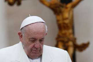 Pope Francis walks near a crucifix during his general audience in St. Peter&#039;s Square at the Vatican Feb. 14. 