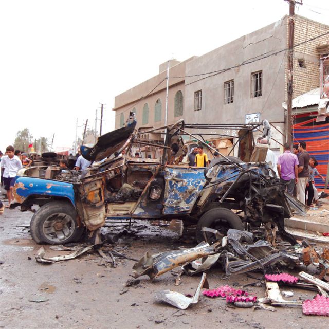 Residents gather at the site of a car bomb attack in Baghdad May 20. The patriarch of the Chaldean Catholic Church denounced a recent series of car bombings and shootings in Iraqi cities that left at least 54 people dead and dozens more injured.