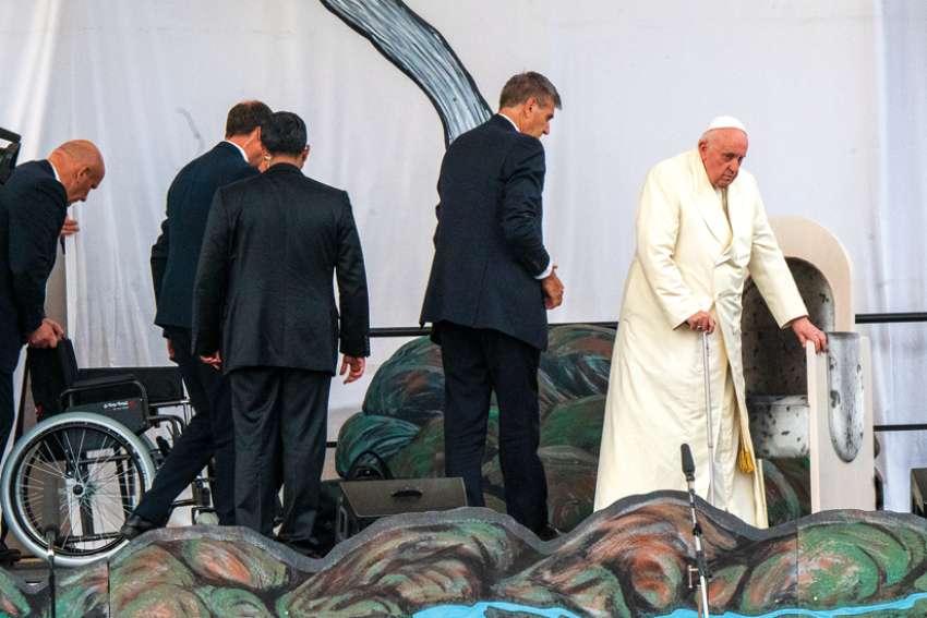 Pope Francis prepares to sit in one of the eight chairs specially designed for his trip to Canada at his stop in Iqaluit. The chairs were designed and manufactured by Quality and Company from Maple, Ont.