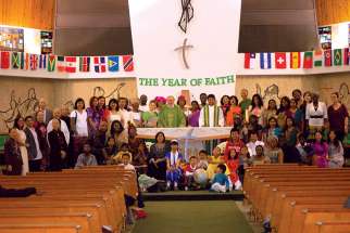 Fr. Massey Lombardi with a few children clad in the traditional garments of their heritage following the Mass that kicked off the Year of Faith at Toronto’s St. Wilfrid’s parish in 2012.