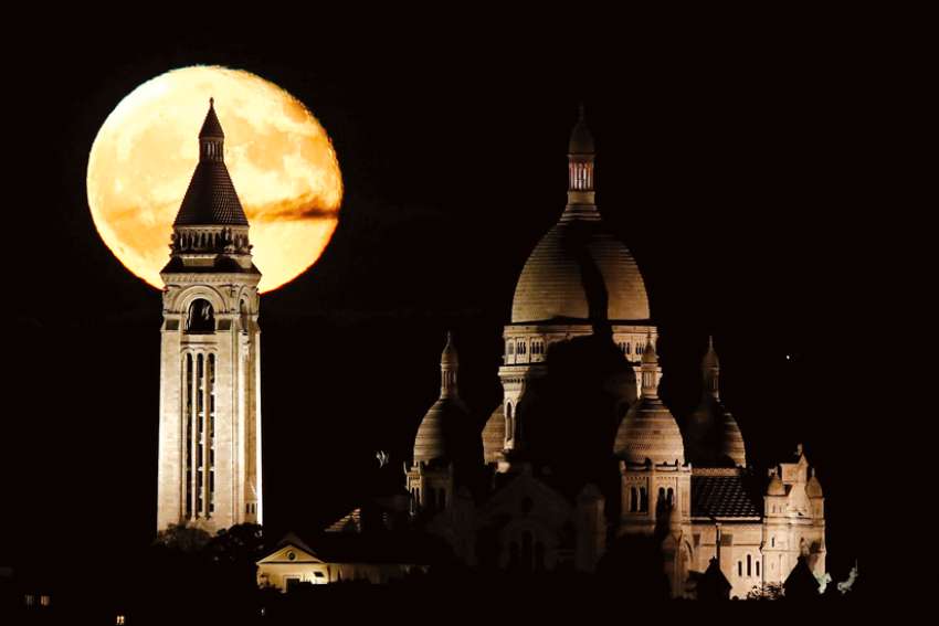The moon, rising over the 19th-century Sacré-Coeur Basilica on Montmartre in Paris, is not for economic exploitation.