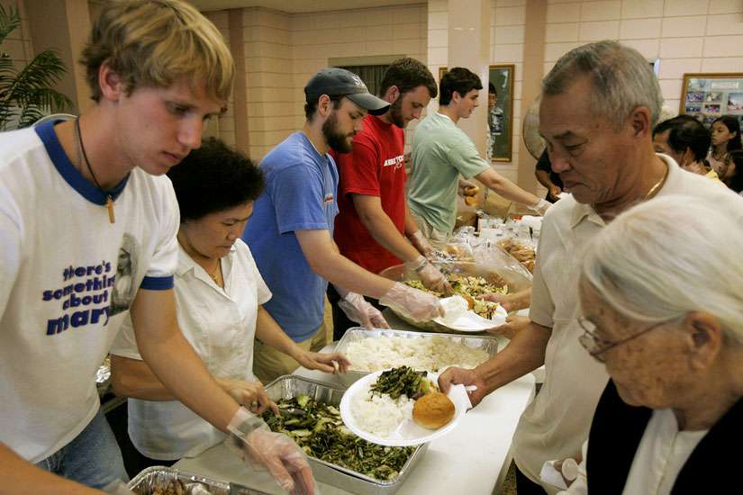 Seminarians serve food to Hurricane Katrina evacuees in 2005 at a temporary shelter in Baton Rouge, La. From the time the storm struck New Orleans through February 2006, Catholic Charities in the Baton Rouge Diocese served 103,187 people, and received more than $17 million in grant funding that was distributed in myriad of ways. 
