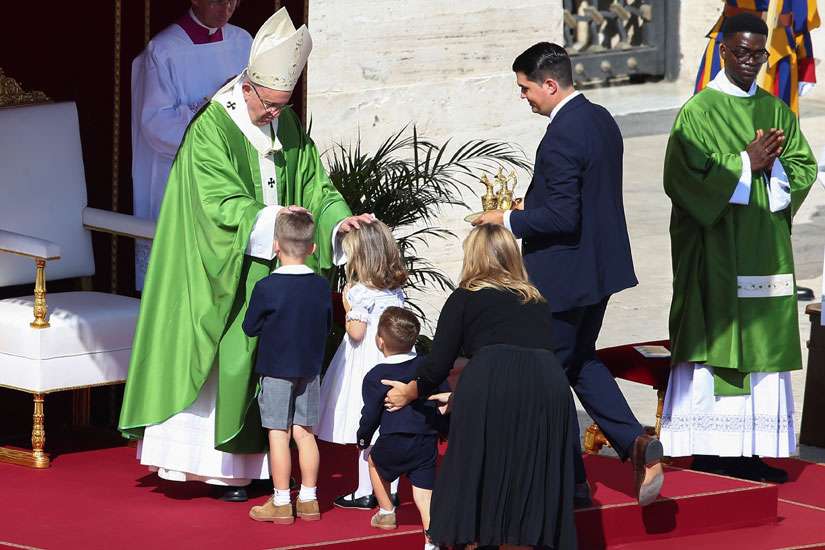 Pope Francis blesses a family as he celebrates a Mass for the Jubilee for Catechists Sept. 25 in St. Peter&#039;s Square at the Vatican.