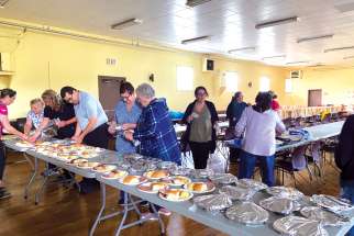 Parishioners at Holy Family Church in Sydney Mines, N.S., pitch in to prepare meals for those affected by post-tropical storm Fiona.