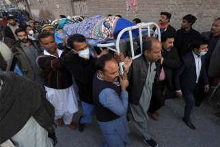 Men carry the body of Church of Pakistan assistant lay Pastor William Siraj, who was was killed by unknown armed men while on his way home from church in Peshawar, Pakistan, Jan. 30, 2022. One of his traveling companions, Pastor Naeem Patrick, was wounded in the attack.