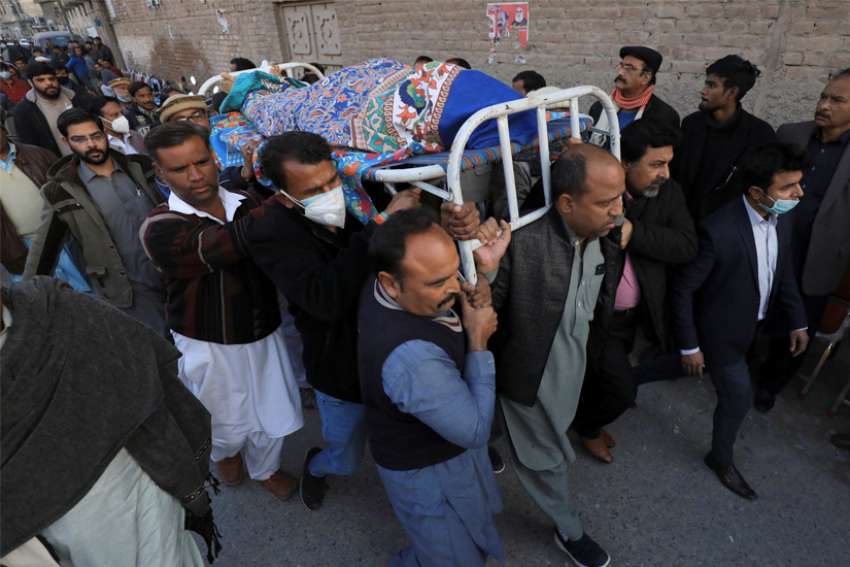 Men carry the body of Church of Pakistan assistant lay Pastor William Siraj, who was was killed by unknown armed men while on his way home from church in Peshawar, Pakistan, Jan. 30, 2022. One of his traveling companions, Pastor Naeem Patrick, was wounded in the attack.