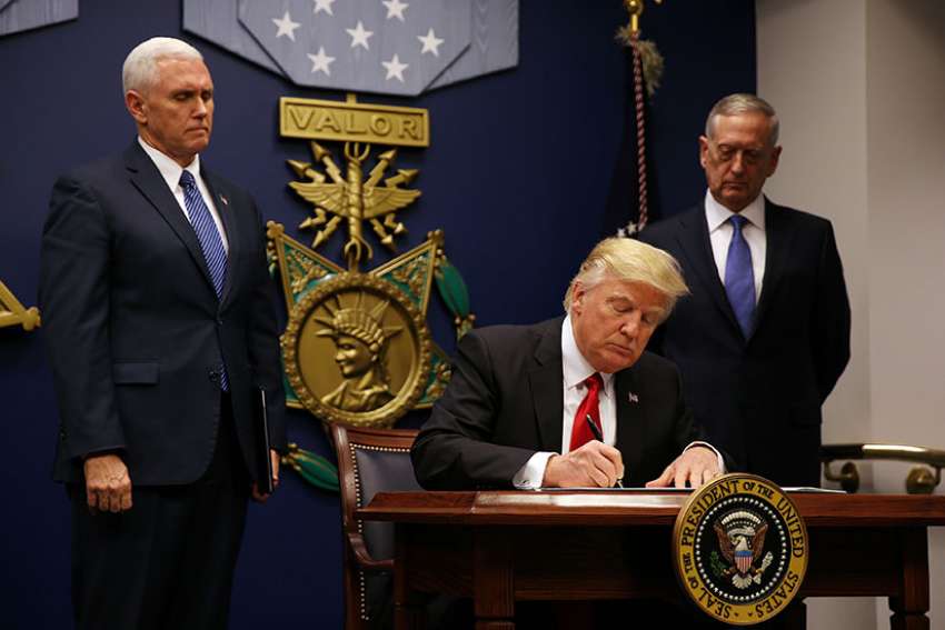 U.S. President Donald Trump signs a revised executive order for a U.S. travel ban at the Pentagon in Arlington, Va. March 6. The Justice Department sent out requests June 1 asking the U.S. Supreme Court to reinstate the ban which has been blocked by a number of district and appeal courts.