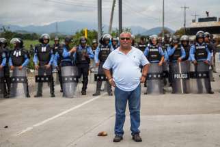  Fr. Ismael “Melo” Moreno, S.J., a prominent human rights advocate in Honduras stands at a protest. 