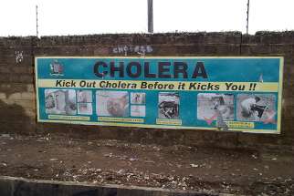 A cholera prevention sign hangs on a street wall in Lusaka, Zambia. 