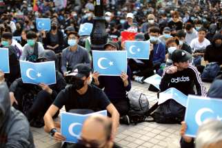 Hong Kong protesters hold East Turkestan Uighur flags at a 2019 rally in support of the human rights of the Uighurs. A Conservative MP has joined calls for legislation to prevent human rights abuses in a corporate accountability law.