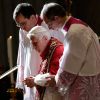 Pope Benedict XVI is assisted by aides as he departs St. Peter&#039;s Basilica at the end of a consistory at the Vatican Nov. 24. During the consistory the pope created six new cardinals from four different continents.