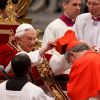Pope Benedict XVI presents a red biretta to Cardinal Thomas Collins of Toronto at the Vatican Feb. 18.