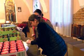 Volunteers with Ukrainian Canadian Social Services in Edmonton prepare goods to help Ukrainian refugees.